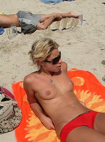 "Fucking hot bitch spreading her tits and pussy on a fucking beach towel, dudes drooling everywhere."