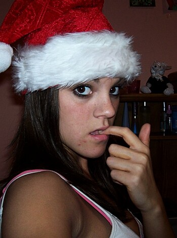 A fucking fatass with a red pointy cap on its head, standin' beside a goddamn Christmas tree and lookin' like an absolute motherfucker.