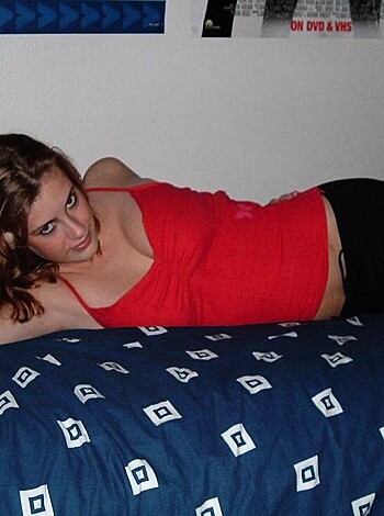 "Damn sexy whore babe lying on her back in black fishnets and a red tee while fucking some dude on the bed."