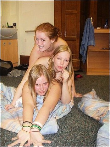 Rewritten as:
A fuckin' three chicks gettin' off in their goddamn bedroom, playin' with their pussies and shit.