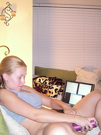 Here's a fucking naked bitch sitting on a couch with a goddamn vibrator in her hand.