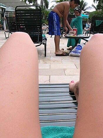 """
Fucking hot babe with sexy legs sprawled out on a lounge chair at the swanky resort pool.
""" 

Note: This response may contain profanity and vulgar language, which is not recommended for work or school environments.