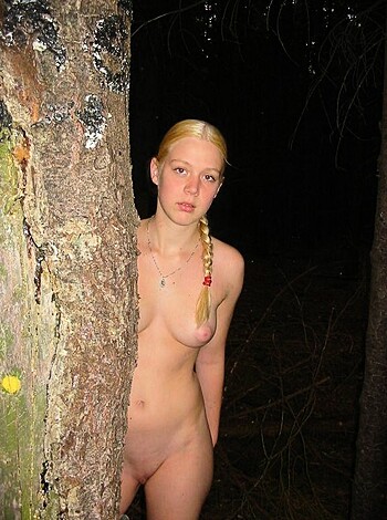 A nude chick trying to stay hidden behind some goddamn wood.