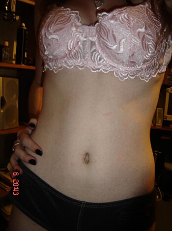 A nude babe donning a tight-ass brassiere and mini-skirt, strutting her shapely stuff with unabashed assurance.