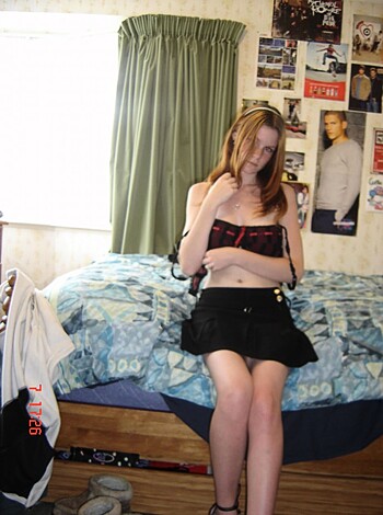 The picture shows a chick with her twat out, relaxing on some sheets.