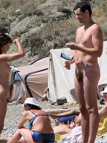 Vulgar description: A fuckin' bunch of naked assholes lounging around on some sandy cocksucker beach, laughing and shit.