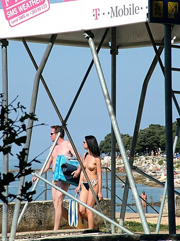 Here's a fuckin' photo of some dude and chick gettin' their asses out on the shoreline, showin' off their goddamn genitals for all to see!