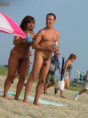 A fucking naked couple basking in the sun with a goddamn blue can in hand, while surrounded by fully-clothed prudes on the beach.