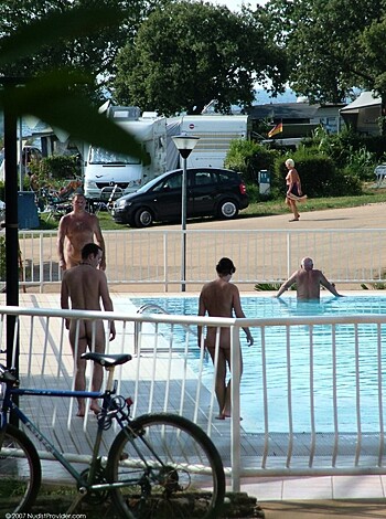 A bunch of nude fuckers chillin by the pool.