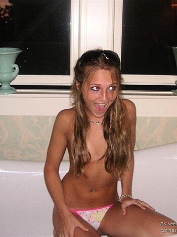 "Fuckin' hot naked chick showin' off her pussy in a bikini and shit while sittin' on a tub with sunnies on her dumb fuckin' head."