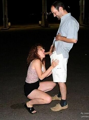 Here's a limit of 25 words:
"This photo shows a dude standing while a bitch is on her knees sucking his dick."