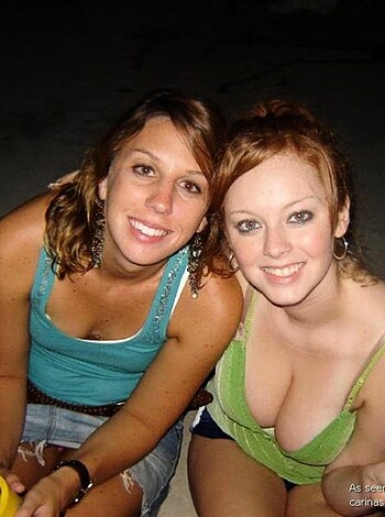 This is an image of two chicks hanging out in their swimwear. The one with the tits and ass is rockin' a tight green bikini top, while her slutty friend is sporting a loose blue tank top that shows off her boobies. They both look like they got fucked good last night, grinnin' from ear to ear like the dick was still in their mouths.