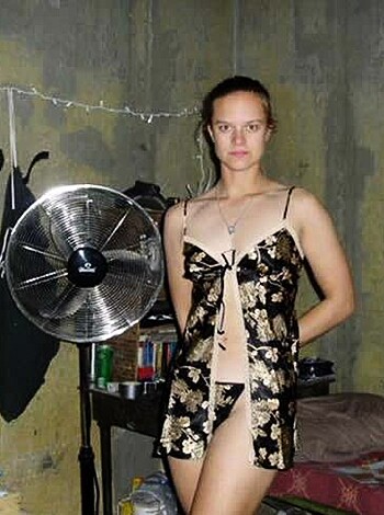 A woman wearing skimpy underwear striking a seductive pose for the camera.