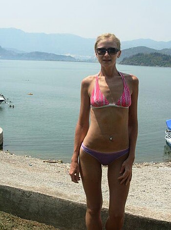 A nude chick with a bikini at the beach, fucking hot.
