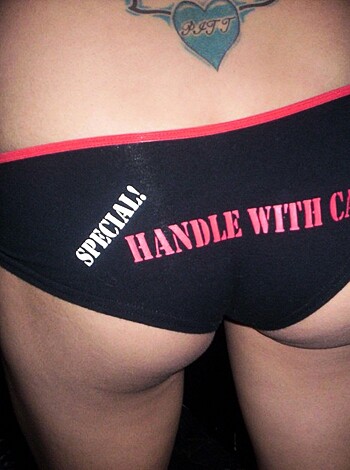 Look at this fucking image of some chick's ass, with her tight black panties covered in red writing.