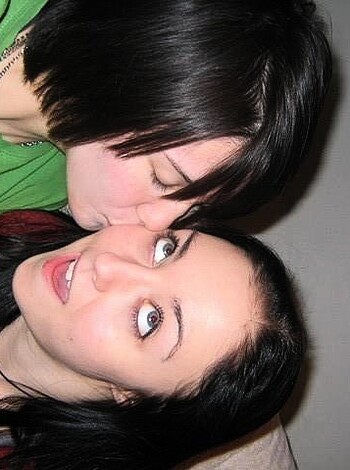 Two chicks going at it like there's no tomorrow, eyes shut tightly.