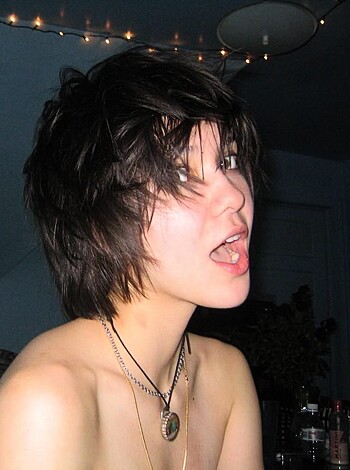 "Fuckin' hot chick showin' off her tits n' shit, posin' like a model with some bling-bling jewelry."