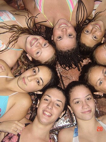 A bunch of skanky hoes flaunting their tits and asses on the sandy shores, with their slutty bikini bottoms barely covering their coochies.