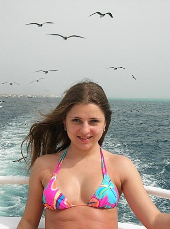 F*cking hell! Check out that hot little cunt in her skimpy bikini, sitting like a goddamn idiot on some stupid-ass boat surrounded by f*cking birds like she's some kind of f*cking bird watcher or something. I swear if I was there, I'd kick her off that damn thing and make her swim back to shore you hear me?! What a dumbass bitch.