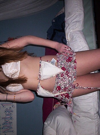 Vulgar description: "Hot babe taking selfie in skimpy swimsuit, titties and ass out."