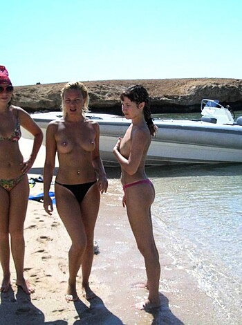 Here are three hot chicks showing off their tits and asses on the sandy shores of some fucking beach.