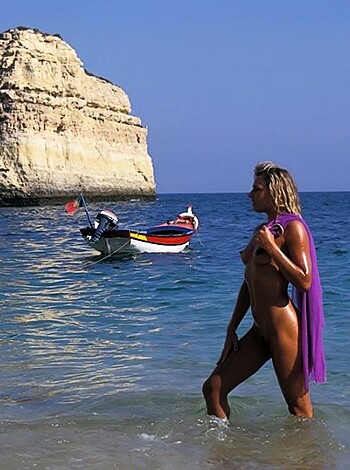 Vulgar description: "Here's a fat bitch on a beach flaunting her ass in a lilac fuckin' cape while some asshole snaps a pic of her."