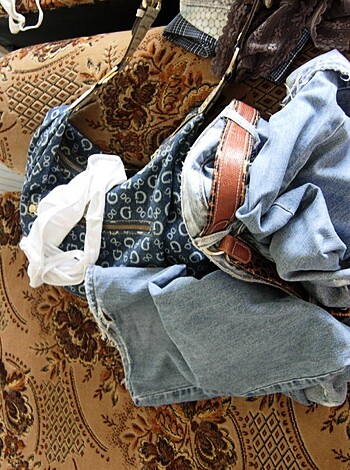A fucking heap of goddamn clothes on a stupid ass sofa.