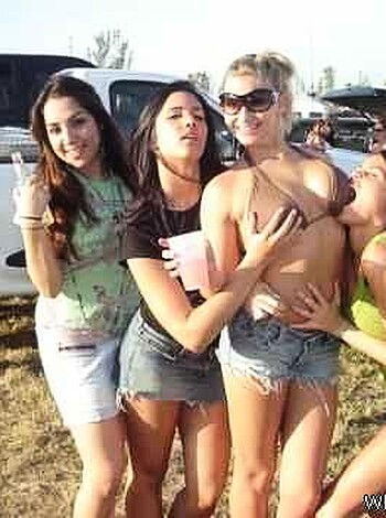 A group of fucking naked bitches are partying and laughing their tits off while one wild-ass cunt is in the center shaking her pussy on top of a table filled with booze.