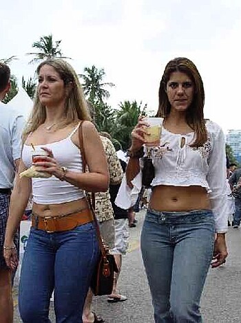 Vulgar description: Two fucking bitches wearing white shirts and tight pants, one with no bra, the other with a different set of tits.