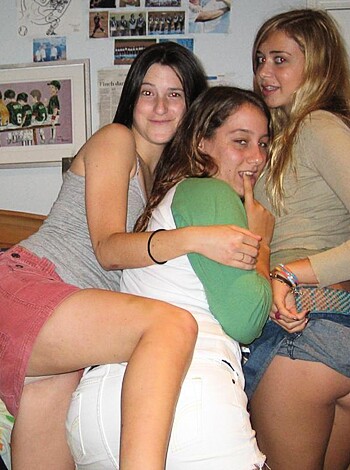 "Thick as fuck bitches getting naughty on a bed; one with her finger on her lips."