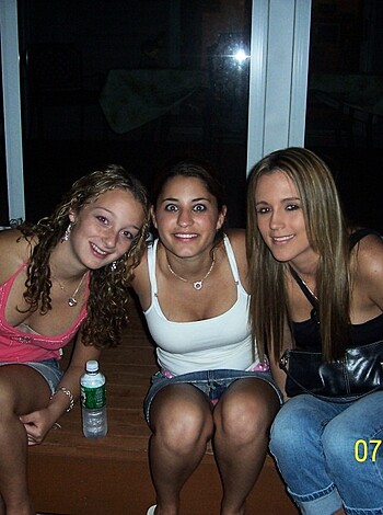 Here's a vulgar description of the image. Three busty titty mammaries with big asses sitting on a bench, one with a water bottle.