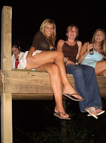 "Three hot babes with no panties, chilling barefoot on the dock, showing off their titties and shit."