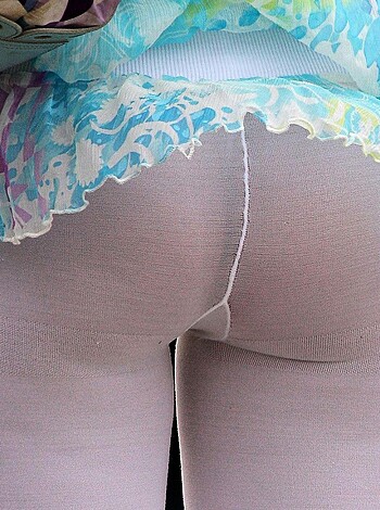 A fucking close-up shot of a bitch's bare legs covered in spandex, with her stupid ass wearing fucking nylons that make her look like a prostitute.