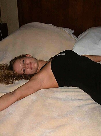 This is a fucking picture of some bitch posin' like a slut on a goddamn bed, with her cunt spread wide open for the world to see.