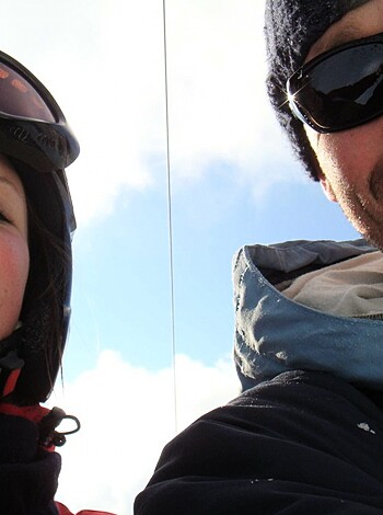 A couple is getting their jollies on a ski lift, grinding away and making sure to get some action while they're up in the air.
