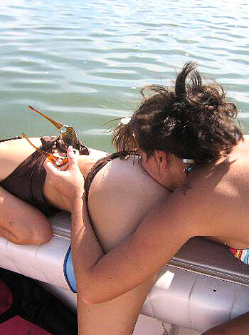 "Here's a fucking image of two hot chicks making out on a goddamn boat while wearing sexy-ass bikinis."