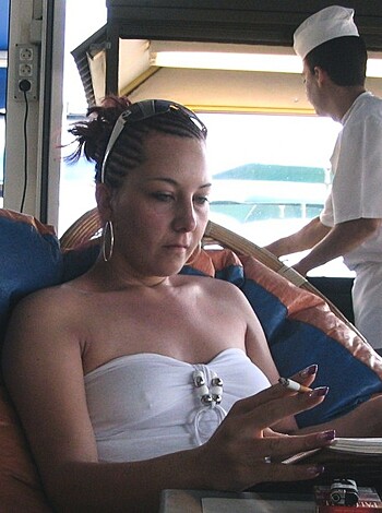 A chick with her ass up in the air and her hand holding her phone, fucking scrolling through some shit while her mouth is full of food.