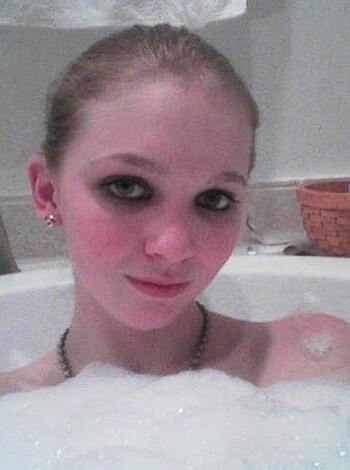 The fuckin' chick is in the tub with a dick-sucking necklace and matching earrings.
