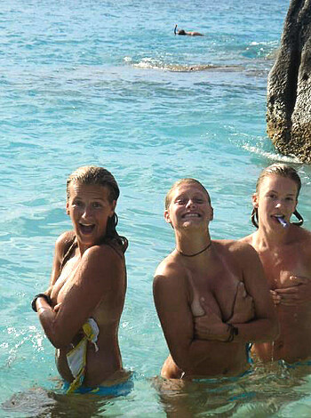 Here's some hot ass chicks flauntin their tits and asses on the fuckin beach, takin pics like they own the goddamn place.