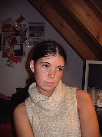 A tight-assed broad with a shawl on, giving the finger to the lens.