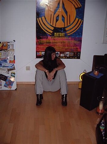 A hot babe with black boots and black top, fucking sitting on her ass like a total fucking badass.
