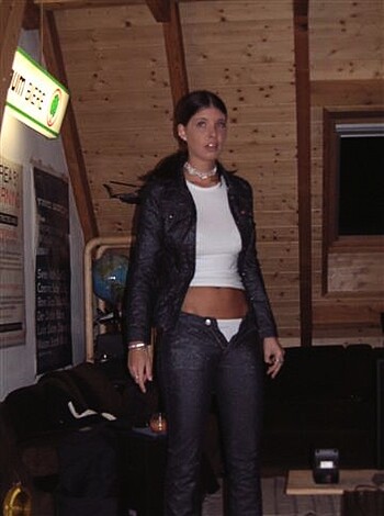 "Look at this hot bitch in that skin-tight leather jacket and barely there denim, showing off her toned abs for all to see."