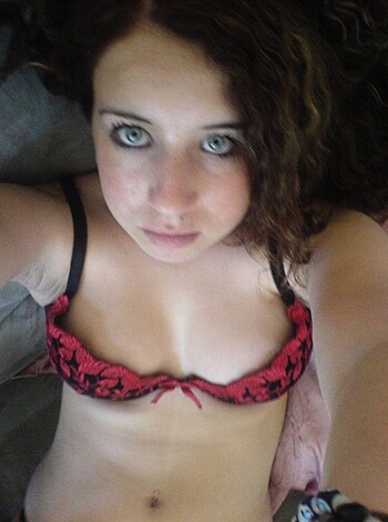 Vulgar description: "Here's a hot blonde bitch in red lacy panties, lying on her back with her legs spread open for your viewing pleasure."