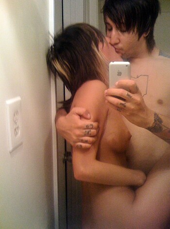 "Fucking horny couple snapping a grimy selfie with their asses up against the brick wall, getting all sweaty and dirty."