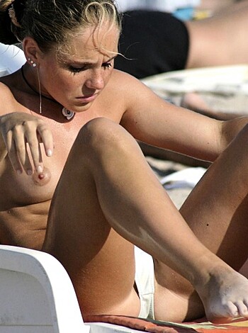 "Here's a picture of some slutty bitch sunbathing without any clothes on except for some goddamn dangly earrings and fucking bangles."
