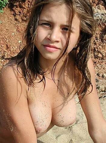 """
Here are two big-titted chicks showing off their knockers while sunbathing on the sandy shoreline.
"""
