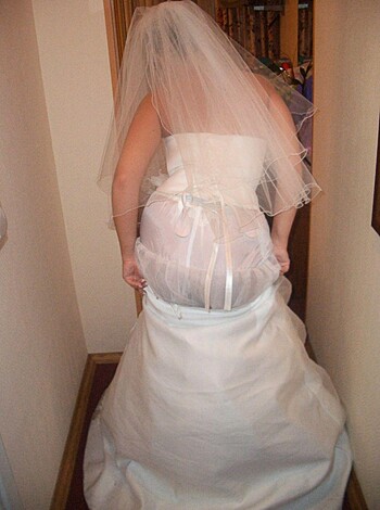 Here's a fucking picture of a bride with her ass sticking out of her gown, taking a look at the shit that she left behind on her way to marry some cunt-face dude in church.
