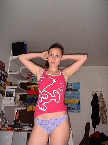 A busty broad, clad only in her underwear, stands in an undressed state, with her tits up in the air, while waving her hands frantically like a fucking lunatic!