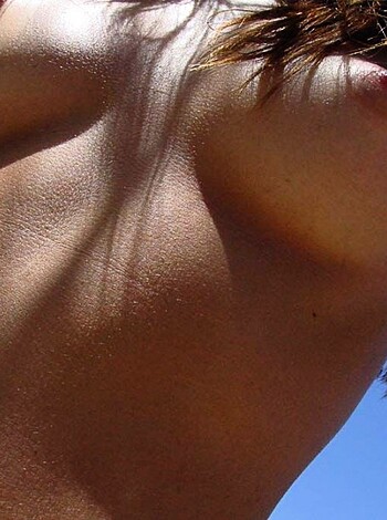 A chick's tits and underarm hair is on display.