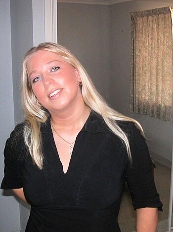A bitch in black ass-tight dress, smile plastered on her face like she's fucking ecstatic to be there.